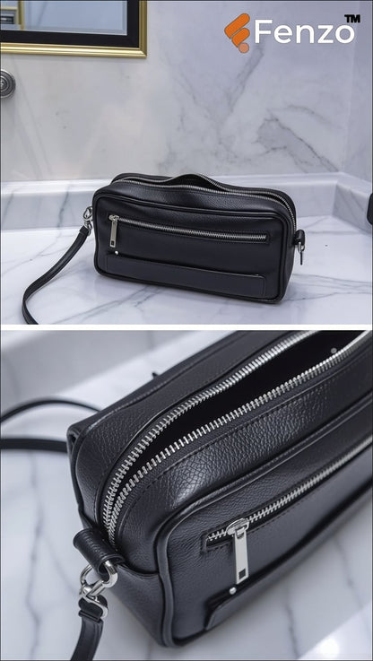 Front view of sleek black leather clutch bag by Fenzo with silver metal zipper.