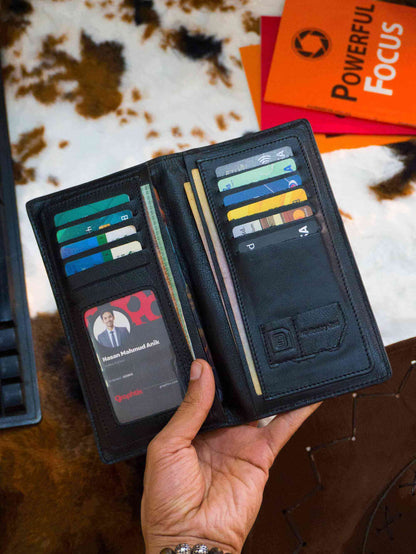 Luxury black leather bifold long wallet holding credit cards and documents for a minimalist executive look