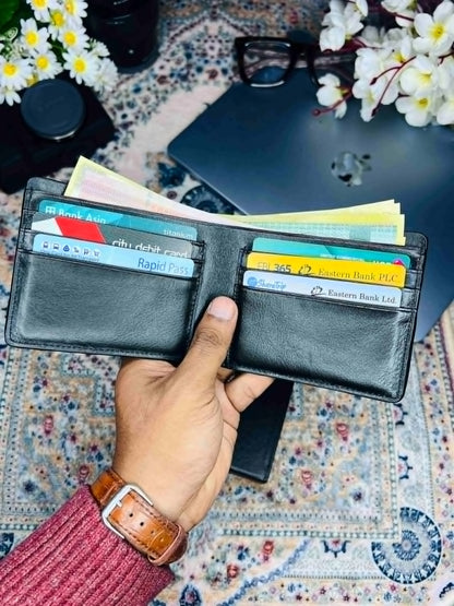 Handheld close up shot of Fenzo classic black genuine leather bifold wallet
