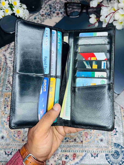 Luxury black genuine leather long wallet for men placed on a wooden desk