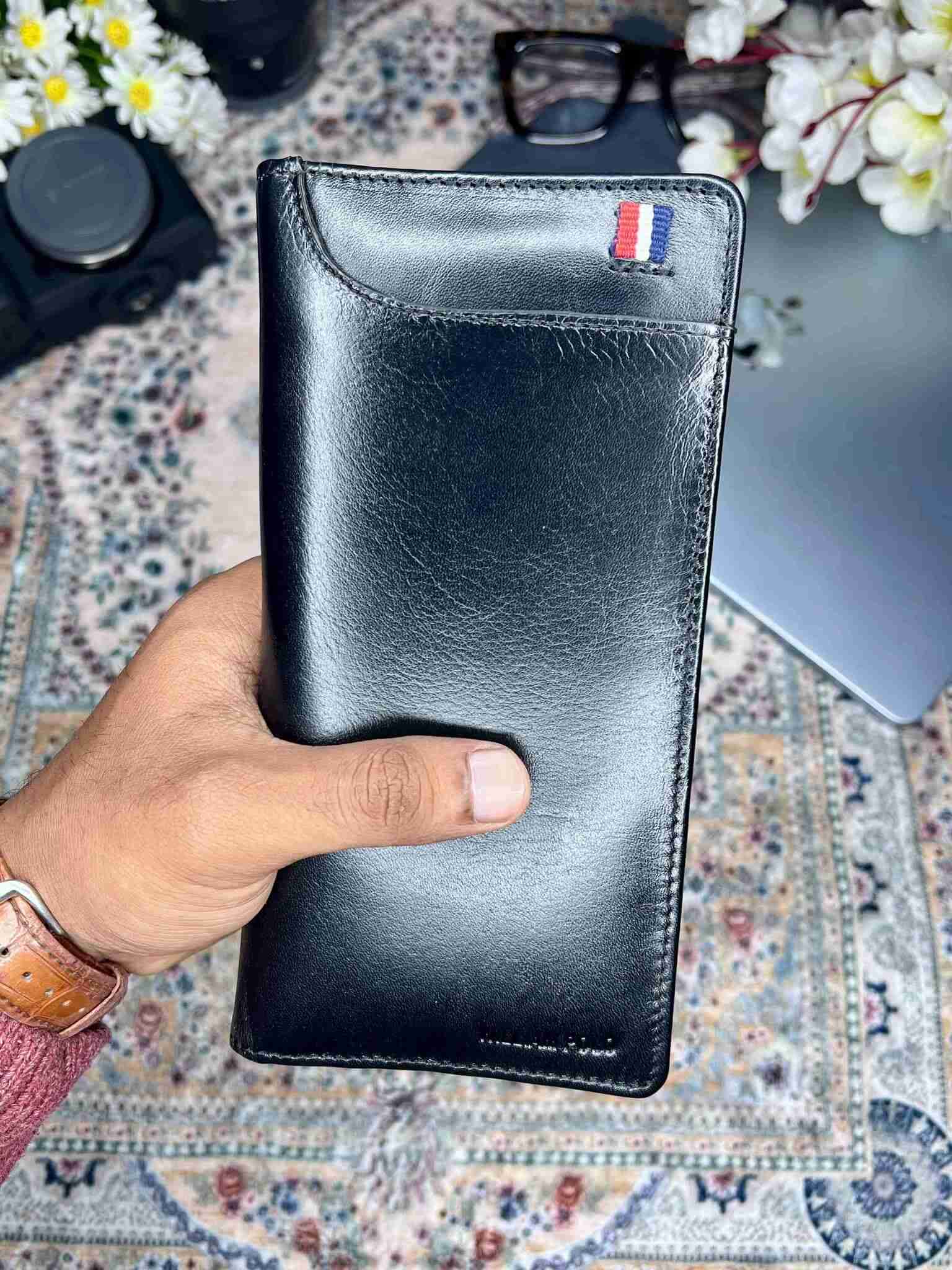 Slim and elegant black leather long wallet with signature metal accent logo